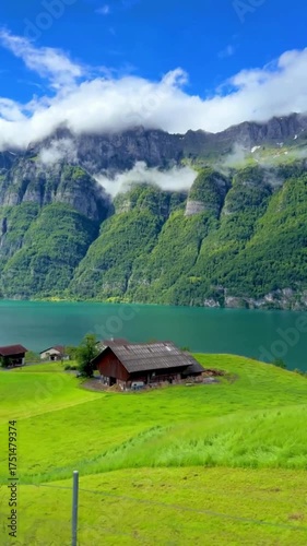 Idyllic Swiss/Alpine Landscape: Turquoise Lake, Majestic Mountains, and Green Pastures with Chalets 4K