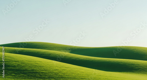 Rolling green hills under a clear sky, creating a serene and peaceful landscape, evoking a sense of tranquility and natural beauty in the countryside