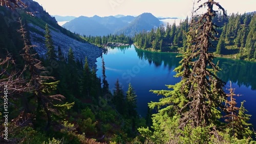 A breathtaking view of the vibrant blue waters of Lake Valhalla, nestled amidst the stunning wilderness of Washington and part of the iconic Pacific Crest Trail
