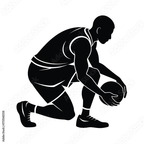 Silhouette of a basketball player crouching with a ball