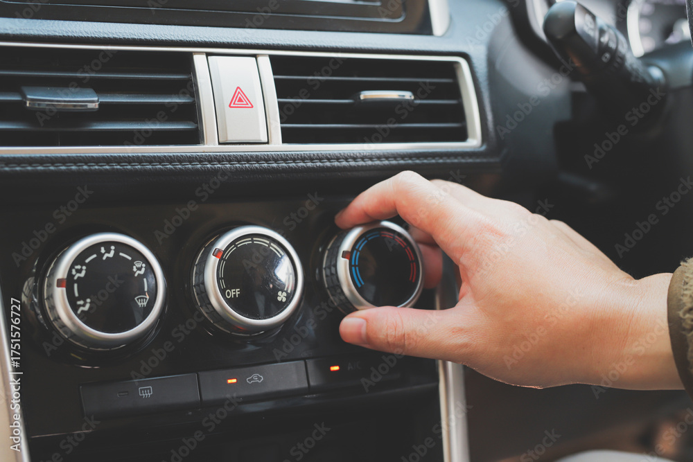 Fototapeta premium close up hand air conditioning and center console of car for temperature.