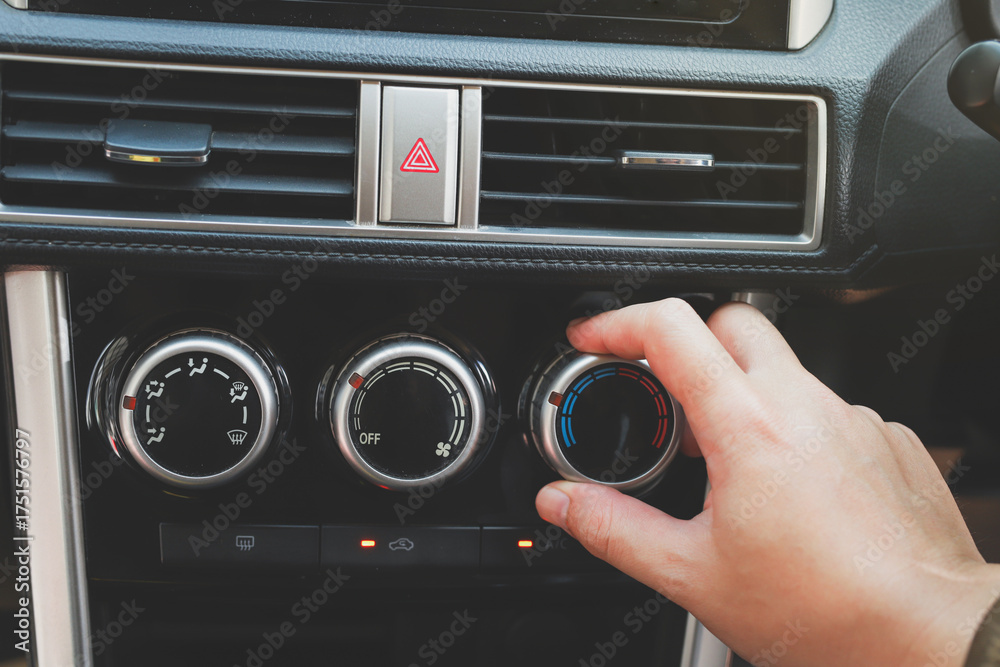 Fototapeta premium close up hand air conditioning and center console of car for temperature.