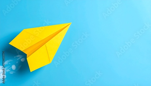 Yellow paper airplane taking flight on light blue background