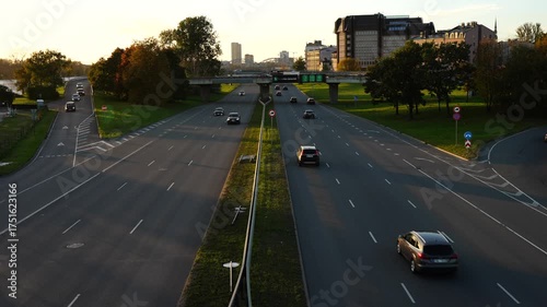 Aerial view of multi-lane city highway with cars driving in both directions in Riga, Latvia during evening light showing modern transport infrastructure, urban mobility and road system efficiency