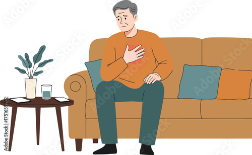 Elderly man sitting on couch holding his chest with worried expression indicating heart discomfort