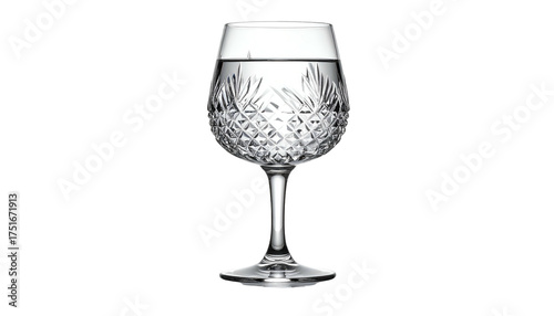 Cut crystal wine glass filled with clear liquid on black