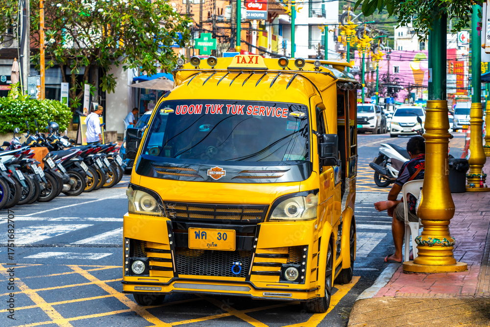 Fototapeta premium Yellow public transportation tuk tuk car taxi in Phuket Thailand.