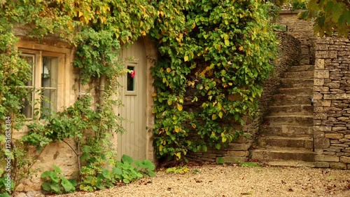 Stone cottage with climbing ivy in the Cotswolds. Cotswolds countryside, England
