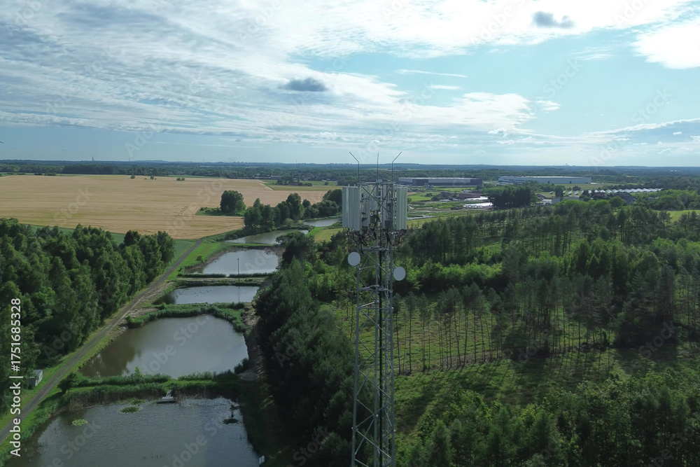 Fototapeta premium Telecommunication mast in green fields