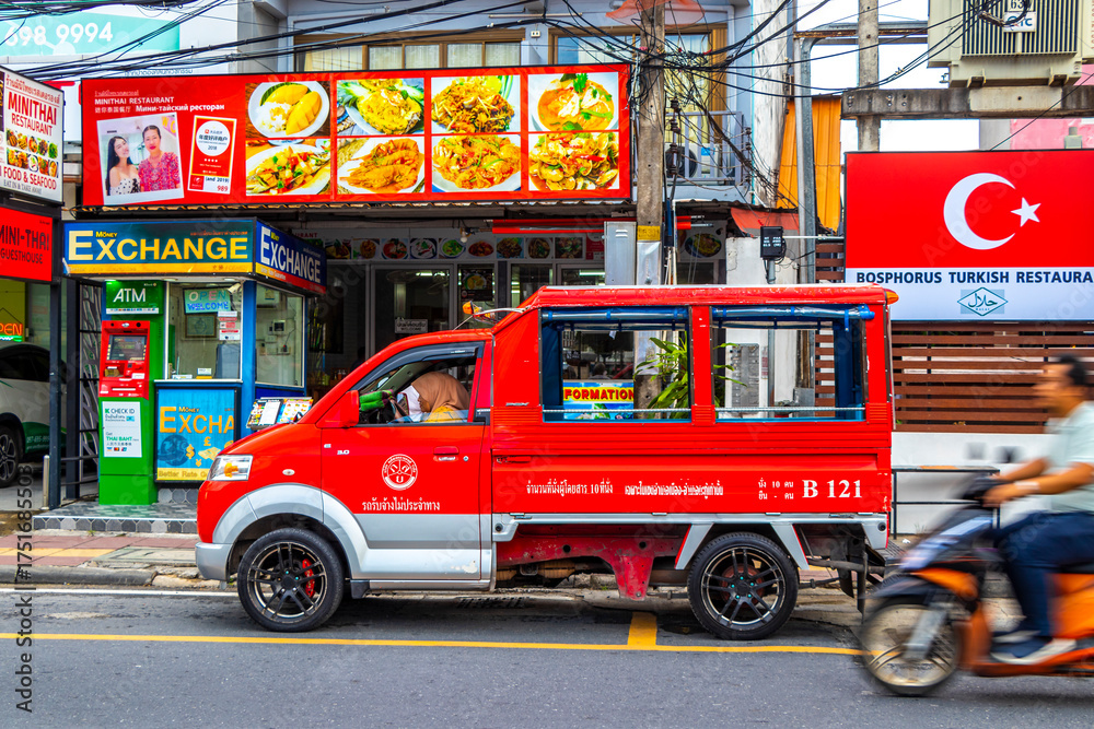 Fototapeta premium Red public transportation tuk tuk car taxi in Phuket Thailand.