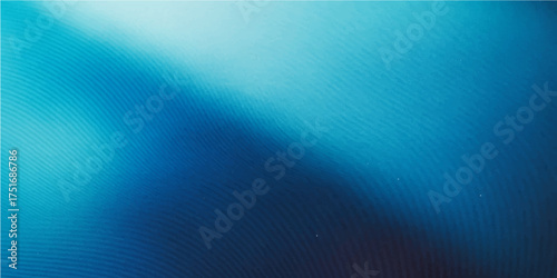 Bright, abstract blue background with light rays, a textured ocean wave pattern ideal for a wallpaper design
