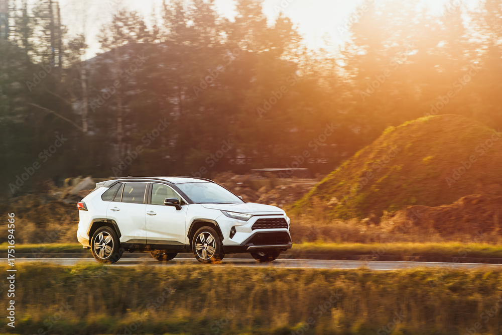 Fototapeta premium Driving SUV on nature road in autumn