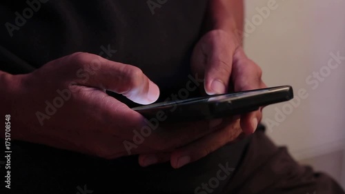 A man scrolling on social media apps or searching for information online on his smartphone