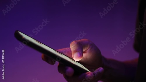 A man scrolling on social media apps or searching for information online on his smartphone