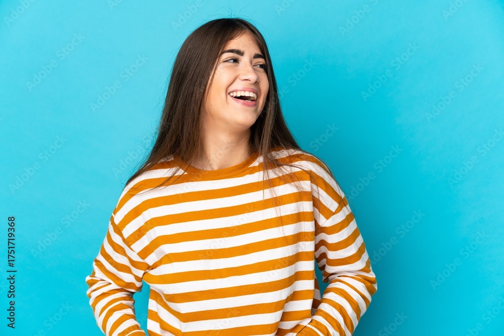 Fototapeta premium Young caucasian woman isolated on blue background laughing
