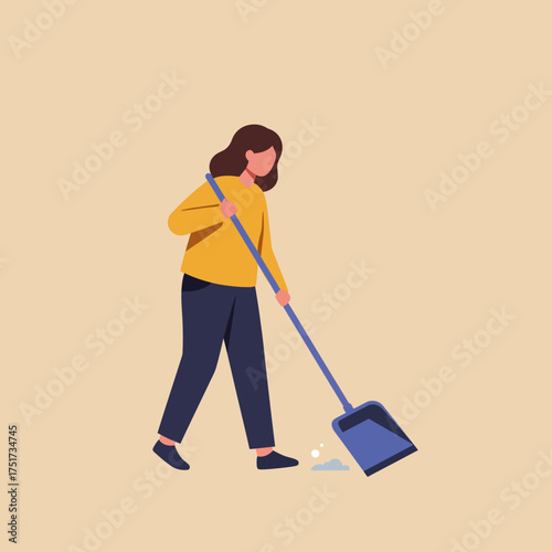 A woman in casual clothing diligently sweeps up small debris with a dustpan and broom on a plain background, illustrating a common household chore.