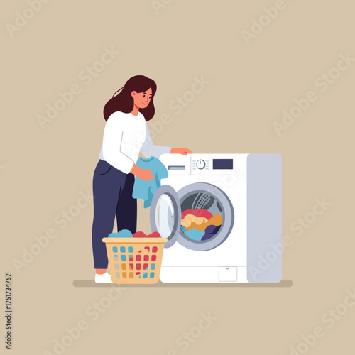 A woman is loading laundry into a modern washing machine, with a basket of clothes beside her.