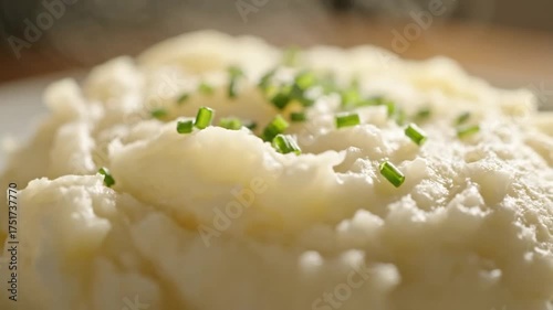 Creamy mashed potatoes with fresh chives on top, a comforting side dish