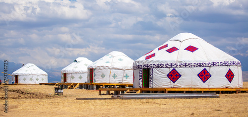 Yurt. National ancient dwelling of the peoples of Kazakhstan and Asian countries. National dwelling. Yurts against the backdrop of green meadows and highlands. Yurt camp for tourists in the mountains.