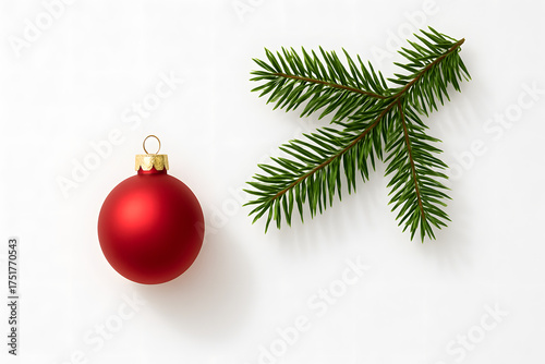 Red matte Christmas bauble and fir tree branch on white background