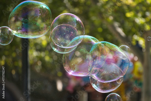 Soap bubbles floating outdoors reflecting abstract colors