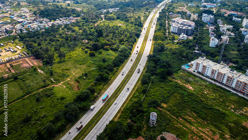 Arial shot of Beautiful road infrastructure of karnataka in India. Aerial view city traffic Highway road with car vehicle movement
