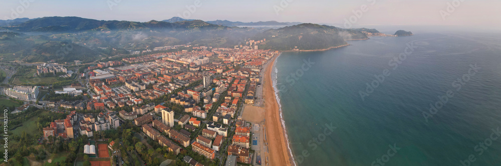 Fototapeta premium Panoramic aerial view of Zarautz town on summer sunrise. Gipuzkoa, Basque Country, Spain.