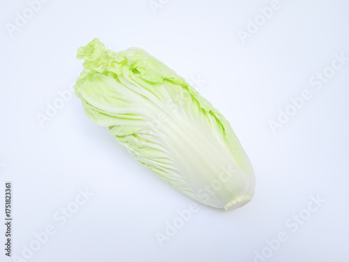 Fresh Napa cabbage with crinkled pale green leaves and a firm white base, set against a clean white background, perfect for culinary, botanical, or stock use.