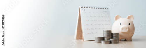 Fotografía budget, planner, savings, piggybank, finance, goals, A pink piggy bank beside a calendar with stacked coins represents monthly savings planning, financial goals, and money management concepts