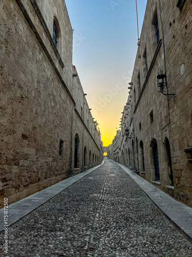 A charming narrow street illuminated at sunset, showcasing beautiful historic architecture