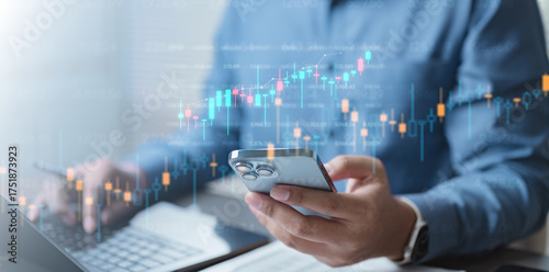 Fotografi A person analyzing investment data on a smartphone and laptop with stock charts overlayed, representing portfolio management, financial planning, and wealth growth