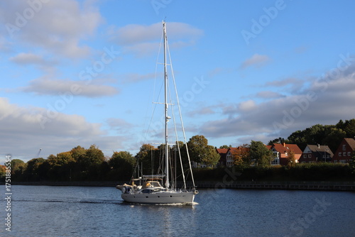 Sailing yacht on a river near the shore