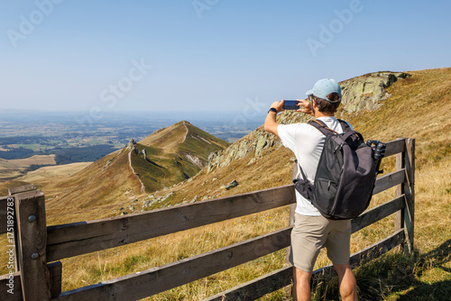 A tourist taking a picture of the Super-Besse landscape with his smartphone