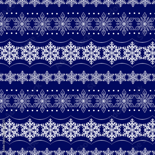 A magnificent ornament of openwork snowflakes.Vector seamless pattern with beautiful white snowflakes on a blue background.