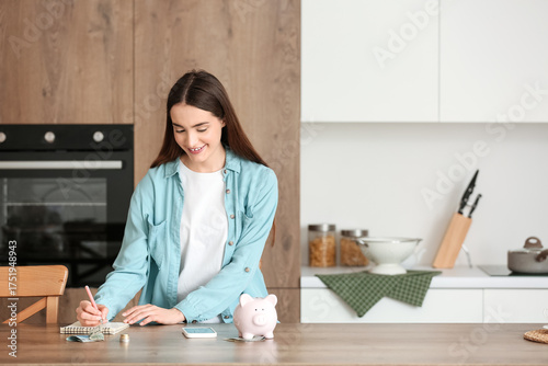 Young woman with piggy bank...