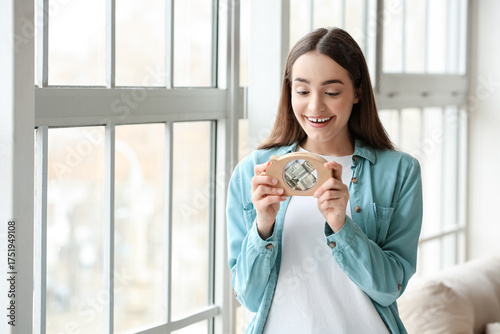 Happy young woman with pigg...