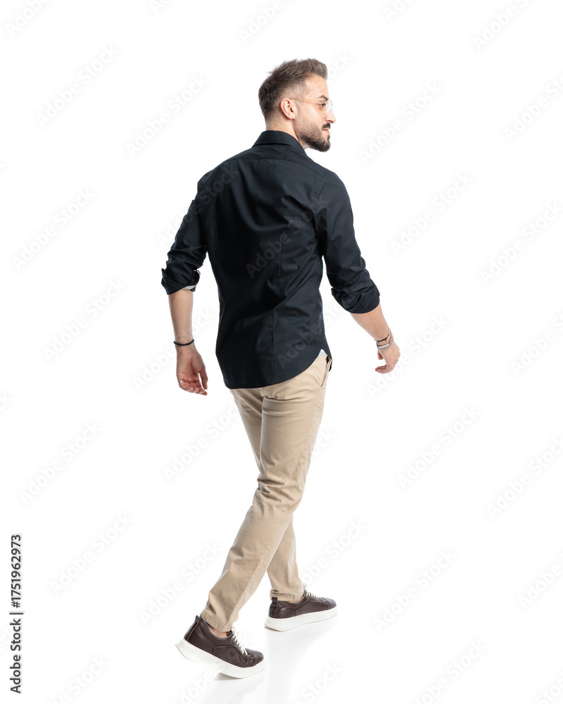 Fototapeta premium behind view of young man with glasses smiling and looking to side