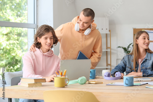 Happy students studying at ...
