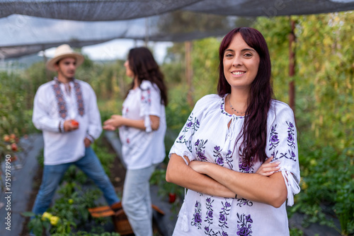 Fotografía Woman smiling in traditional romanian blouse at garden house