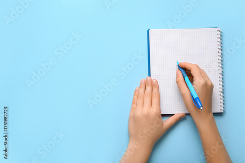 Female hands writing in not...