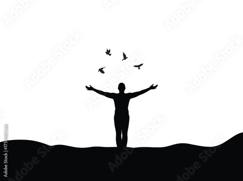 Silhouette of a person releasing birds into the sky