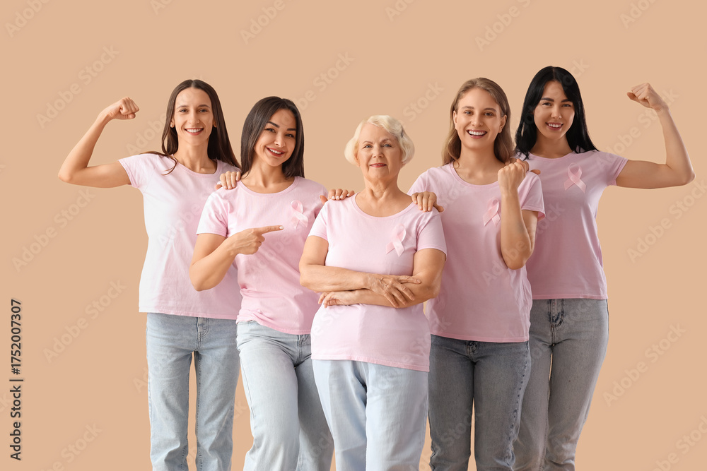 Obraz premium Group of beautiful women with pink awareness ribbons on beige background. Breast cancer concept
