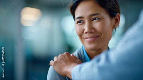 Compassionate doctor touching patient’s shoulder reassuring gesture in focus faces softly defocused empathy in healthcare faceless background defocused bedside manner support