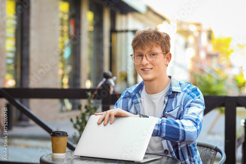 Teenage boy with laptop at ...