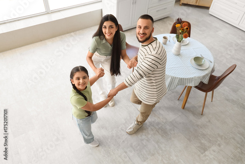 Happy family dancing in kit...