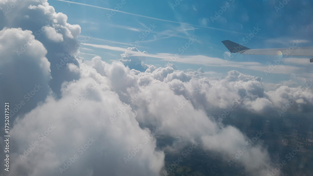Fototapeta premium Flying among the clouds, view from the airplane window
