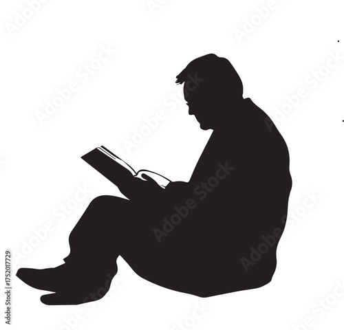 silhouette of a man reading a book