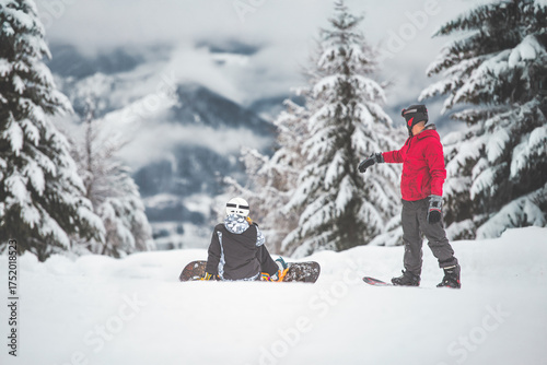 Two snowboarders before a ride