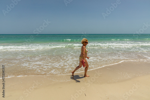 Wallpaper Mural attractive senior man at the beautiful sandy beach in swim suit Torontodigital.ca