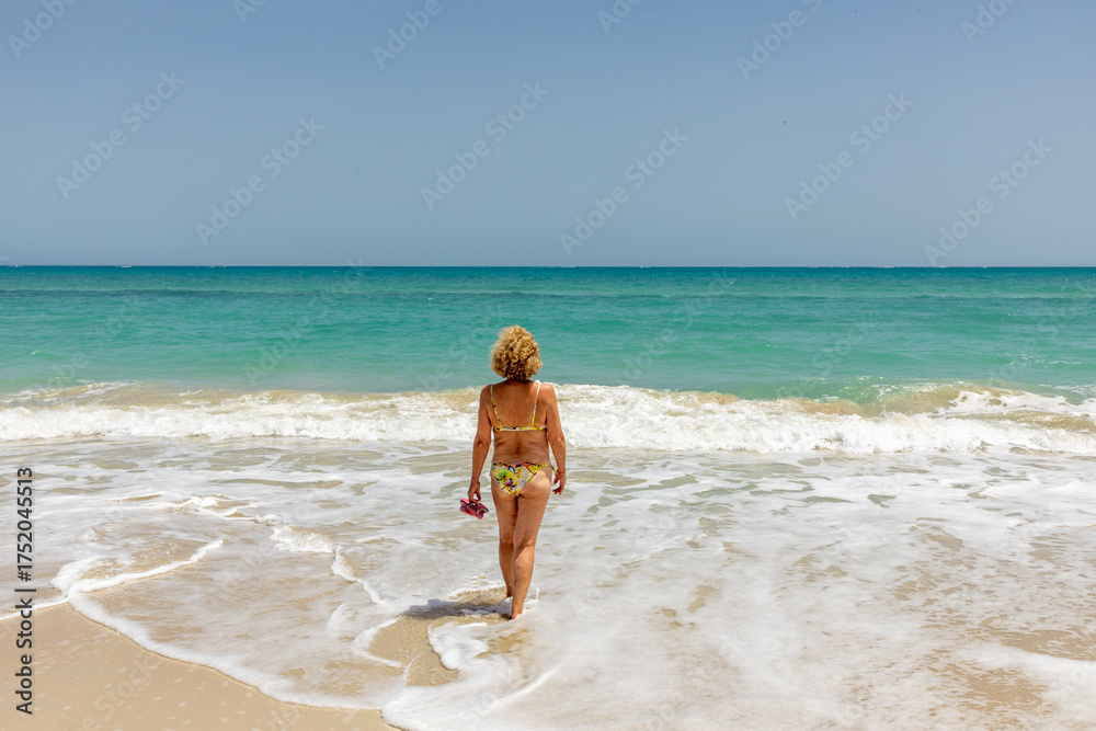 custom made wallpaper toronto digitalattractive senior woman at the beautiful sandy beach in bikini
